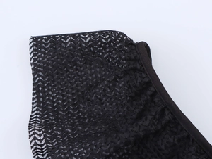 Close-up of elegant black mesh fabric with ruffled edges and detailed diamond netting