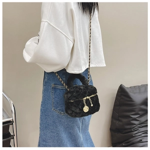 Detail of black faux fur mini crossbody bag with gold rose pendant and chain strap