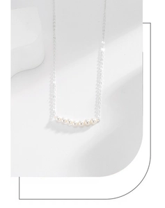 Close-up of S925 silver necklace with seven lustrous white pearls in a row