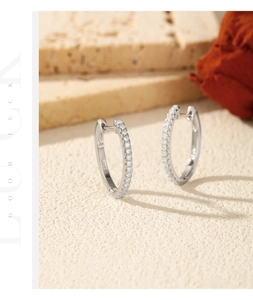 Close-up of S925 sterling silver hoop earrings with sparkling VVS1 moissanite stones