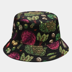 Detailed close-up of a black reversible bucket hat with colorful hand-painted vegetable print