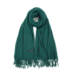 Thick dark green cashmere-feel winter scarf with elegant tassel fringe on white background