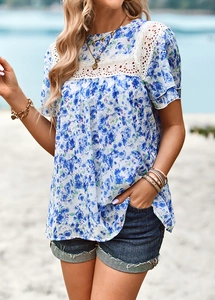 Close-up of floral print top with white lace patchwork on shoulders and sleeves