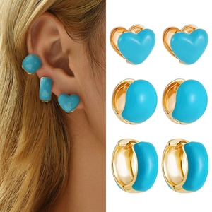 Golden Y2K heart earrings set with turquoise enamel finish on model and still view