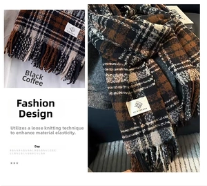 Detail of soft black and coffee plaid knit scarf featuring loose weave and fringe trim