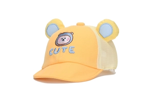 Macro view of cute bear embroidery and 'CUTE' lettering on a yellow baby baseball cap