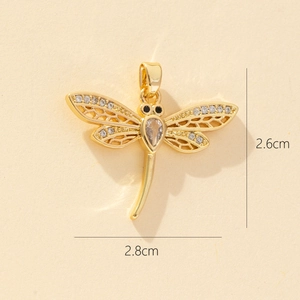 Detail showing a golden dragonfly pendant with micro-pave zircons and size dimensions