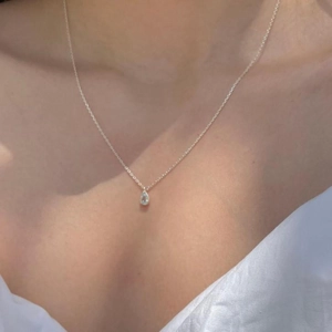 Minimalist 925 sterling silver necklace with teardrop zircon pendant on female model
