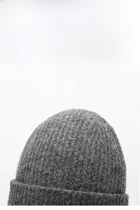 Detail view of grey ribbed knit beanie showing thick vertical texture and warm blend fabric