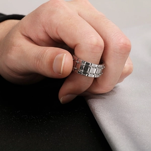 Close-up of industrial punk style stainless steel ring for men on hand in silver tone
