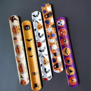 Detailed view of 5 Halloween slap bracelets with pumpkin ghost and bat patterns