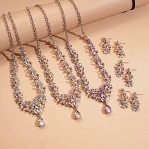Silver leafy necklace and earring set with pink and lavender teardrop gemstones