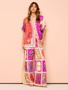 Detail of satin texture and vibrant poker print on the luxury pajama-style summer set