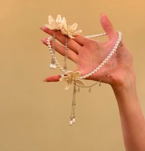 Detailed close-up view of an elegant French style pearl necklace and flower earrings set