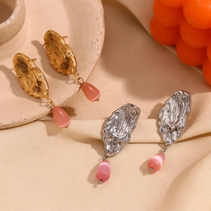Vintage 18K gold plated butterfly wing earrings with pink gemstone drop on fabric