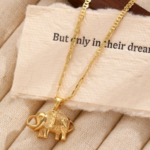 Golden elephant pendant necklace with intricate texture on a vintage paper background