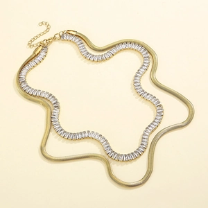 Detail of layered gold snake chain and sparkling crystal rhinestone choker necklace