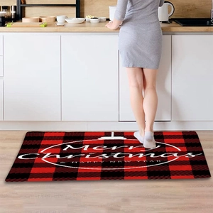 Red and black buffalo plaid Merry Christmas floor mat in a modern kitchen setting