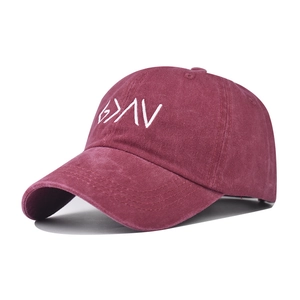 Detail view of burgundy washed cotton baseball cap with white embroidered letters