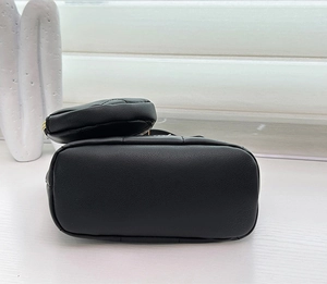 Detail of black pebbled leather tote base with matching small zipper coin purse