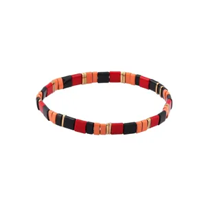 Detail of colorful enamel Tila beads and gold spacer beads on bohemian stretch bracelet