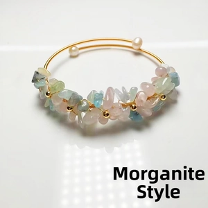 Macro detail of wire-wrapped Morganite stone bracelet with two white freshwater pearls