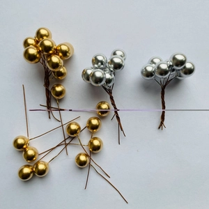 Golden and silver Christmas berries with metallic finish and flexible wire stems on white