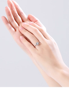 Detailed macro view of a moissanite solitaire ring with a twist rope band design