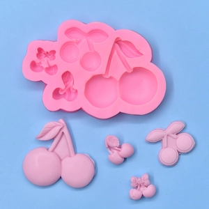 Pink silicone cherry mold with four different shapes and resin finished examples