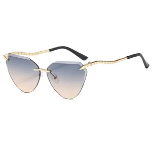 Chic rimless cat eye sunglasses with blue-orange gradient lenses and gold metal spiral legs