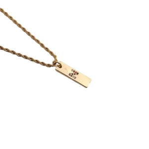 Detail shot of golden twist chain with rectangular pendant featuring a colorful zircon letter Z