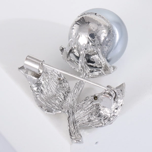 Detail of silver leaf brooch with grey imitation pearl and back pin clasp design