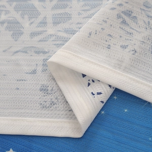 Detail showing the fine stitching on winter-themed snowflake blackout curtains