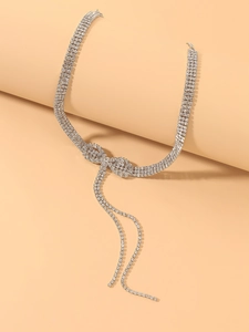 Detail of silver bow tassel choker necklace featuring four rows of sparkling rhinestones