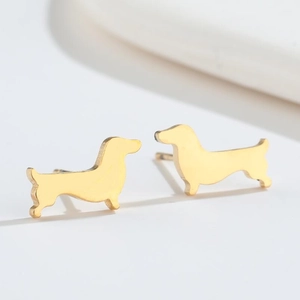 Detailed macro view of small minimalist golden stainless steel dachshund stud earrings