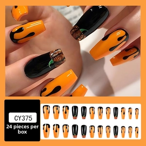 Detail of Halloween coffin nails featuring orange pumpkin faces and black drip patterns