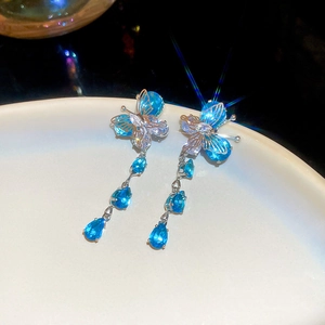 Detail of silver needle blue butterfly earrings with sparkling zircon teardrop tassels