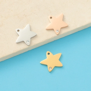 Macro view of mirror polished star-shaped pendants with inlaid crystals in three colors