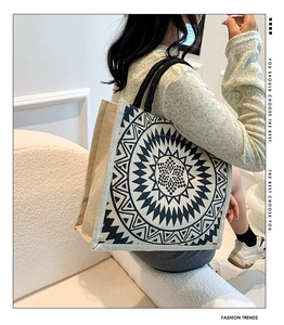 Close-up of linen tote bag with geometric mandala print and sturdy black handles