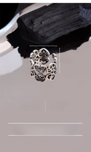 Macro shot of silver-plated vintage hollow heart ring showing S925 stamp and dimensions