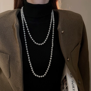 Detail of double-layer dark gray pearl necklace on professional office wear outfit