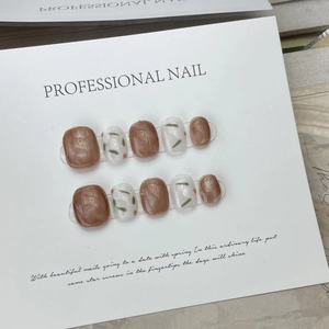 Handmade amber coffee press-on nails with ice camellia floral art and gold trim