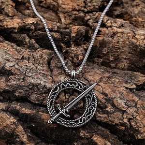 Sword and woven circle stainless steel necklace pendant on rustic bark background