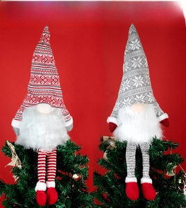 Detail of red and grey knitted Christmas gnome tree toppers with long white plush beards