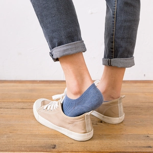 Men's low cut cotton invisible boat socks in vintage blue shown with canvas shoes