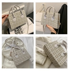 Detailed close-up of white and gold tweed texture on a stylish square crossbody handbag