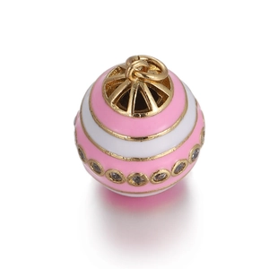 Macro view of gold round charm with pink white enamel and crystal accents for DIY jewelry