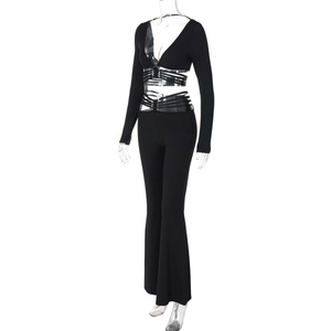 Detail of the black two-piece set featuring a cross-tie V-neck crop top and flared pants