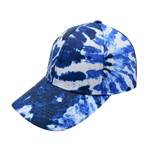 Close-up of blue and white tie-dye baseball cap with curved brim and cotton twill texture