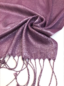 Detail of purple scarf fabric with shimmering silver lurex threads and woven fringe edges